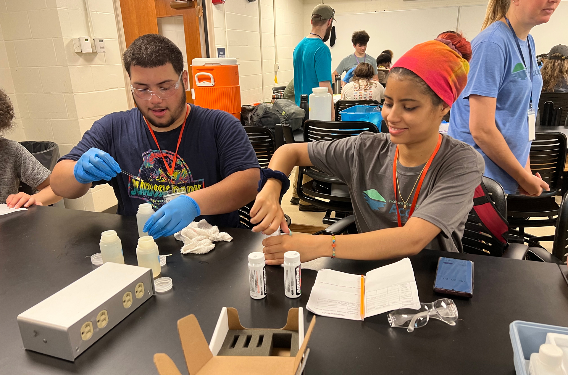 Two students work at a lab table